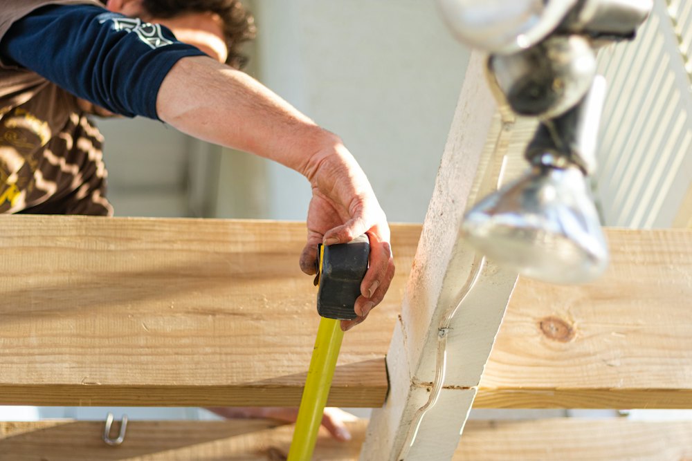 Tape measure pulled across a new deck board
